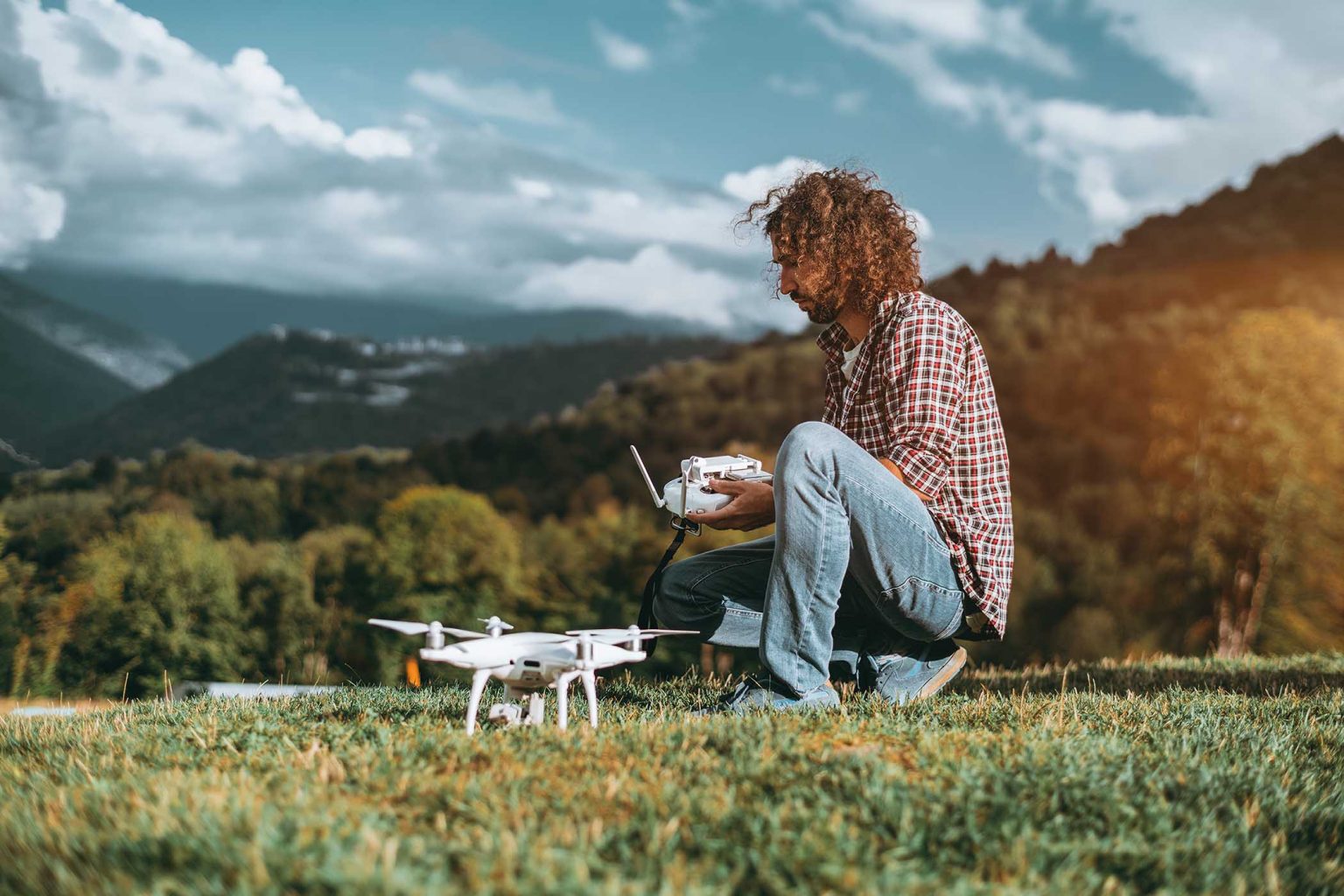 man-in-the-mountains-preparing-to-launch-the-drone-2SBGW2C.jpg